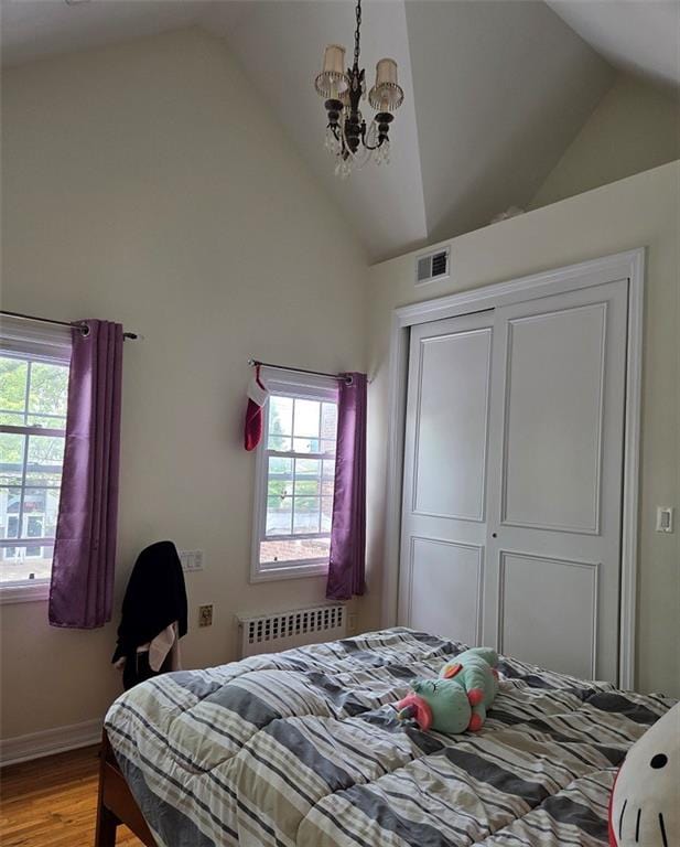 1711 E 36th St, Brooklyn, NY 11234 - bedroom with radiator, wood finished floors, a chandelier, multiple windows, and high vaulted ceiling