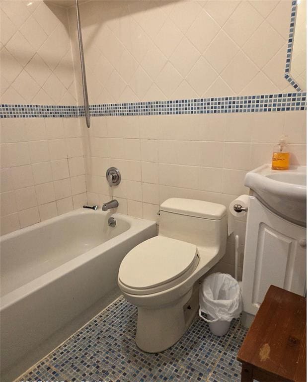 1711 E 36th St, Brooklyn, NY 11234 - full bathroom featuring vanity, bathtub / shower combination, tile walls, tile patterned floors, and toilet