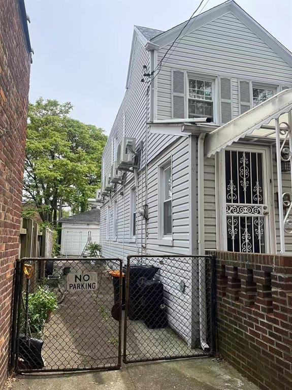 1711 E 36th St, Brooklyn, NY 11234 - view of side of property featuring a gate