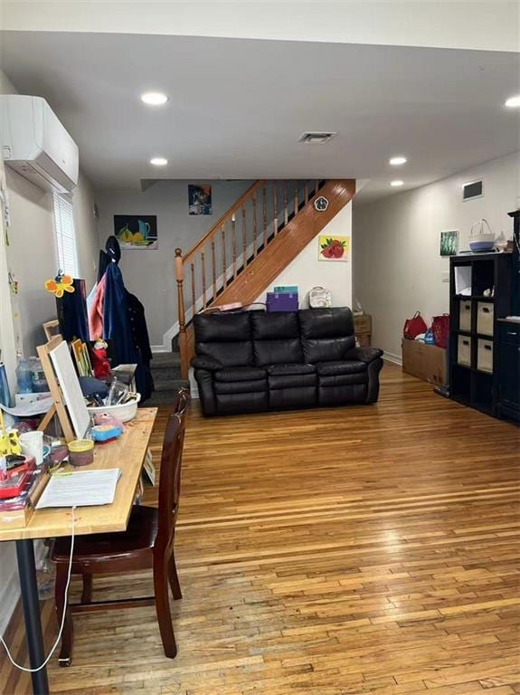 1711 E 36th St, Brooklyn, NY 11234 - living room with a wall mounted AC, hardwood / wood-style flooring, stairs, and recessed lighting