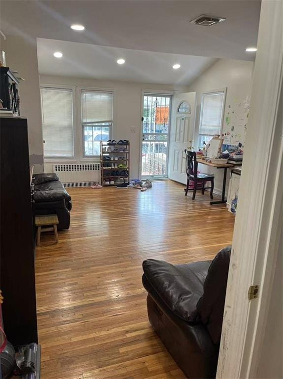 1711 E 36th St, Brooklyn, NY 11234 - living area featuring radiator heating unit, wood finished floors, recessed lighting, and lofted ceiling