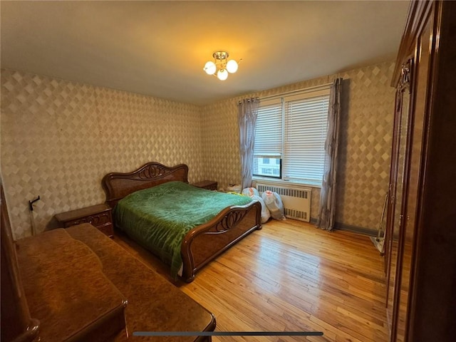 1811 Ocean Pkwy Unit 6-L, Brooklyn, NY 11223 - bedroom featuring radiator, wallpapered walls, light wood-style floors, and baseboards
