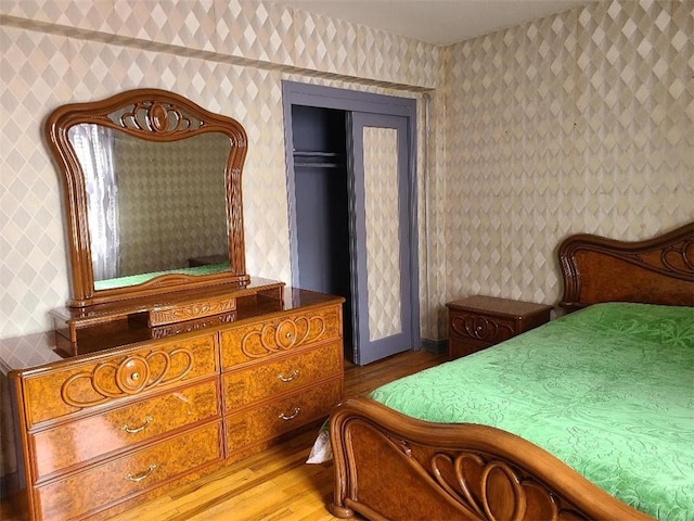 1811 Ocean Pkwy Unit 6-L, Brooklyn, NY 11223 - bedroom featuring wood finished floors, wallpapered walls, and a closet
