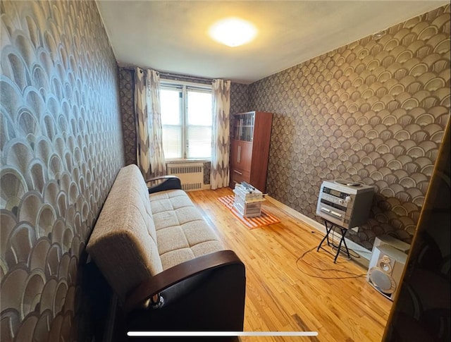 1811 Ocean Pkwy Unit 6-L, Brooklyn, NY 11223 - living room featuring wallpapered walls, radiator heating unit, wood finished floors, and baseboards