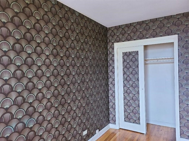 1811 Ocean Pkwy Unit 6-L, Brooklyn, NY 11223 - unfurnished bedroom featuring wallpapered walls, wood finished floors, and baseboards