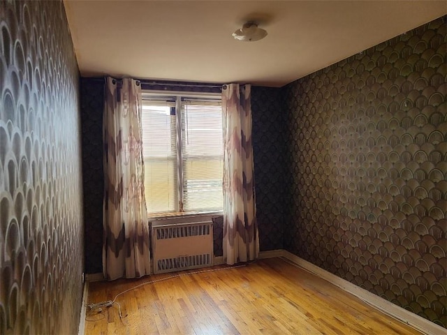 1811 Ocean Pkwy Unit 6-L, Brooklyn, NY 11223 - unfurnished room featuring radiator heating unit, wallpapered walls, and light wood finished floors