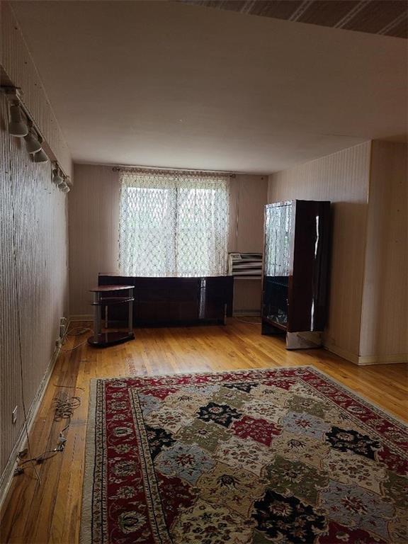 1811 Ocean Pkwy Unit 6-L, Brooklyn, NY 11223 - living area featuring light wood finished floors and wooden walls