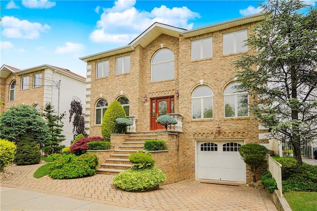 237 Swinnerton St, Staten Island, NY 10307 - view of front facade with a garage, decorative driveway, and brick siding
