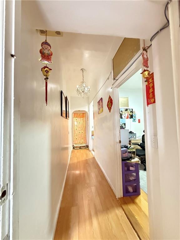 1641 82nd St, Brooklyn, NY 11214 - hallway featuring light wood-style floors, baseboards, and a chandelier