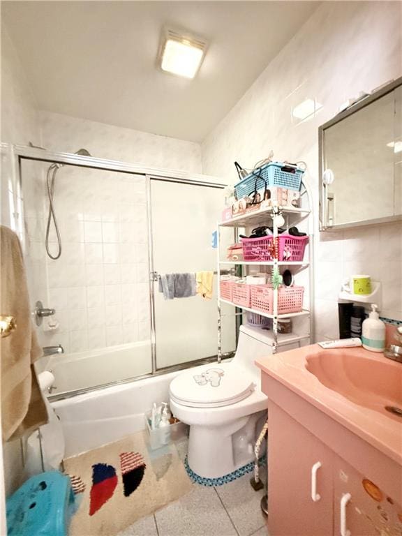 1641 82nd St, Brooklyn, NY 11214 - bathroom with toilet, vanity, combined bath / shower with glass door, and tile patterned flooring