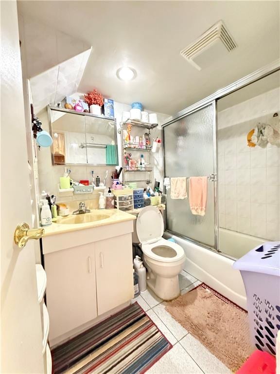 1641 82nd St, Brooklyn, NY 11214 - bathroom with tile patterned flooring, vanity, bath / shower combo with glass door, and toilet