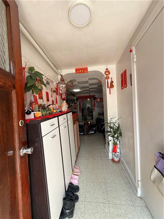 1641 82nd St, Brooklyn, NY 11214 - hallway featuring arched walkways, baseboards, and light floors