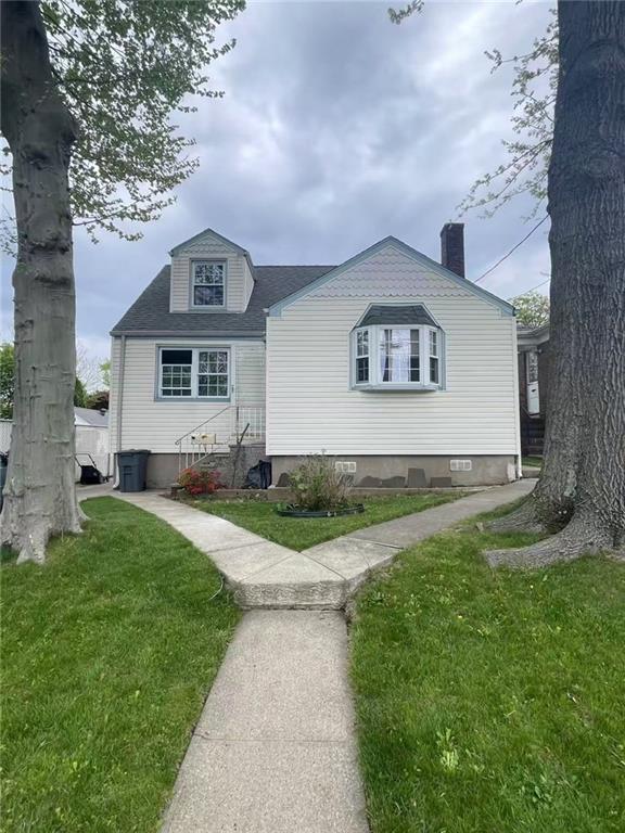 523 Woolley Ave, Staten Island, NY 10314 - view of front of house featuring a front yard and a chimney