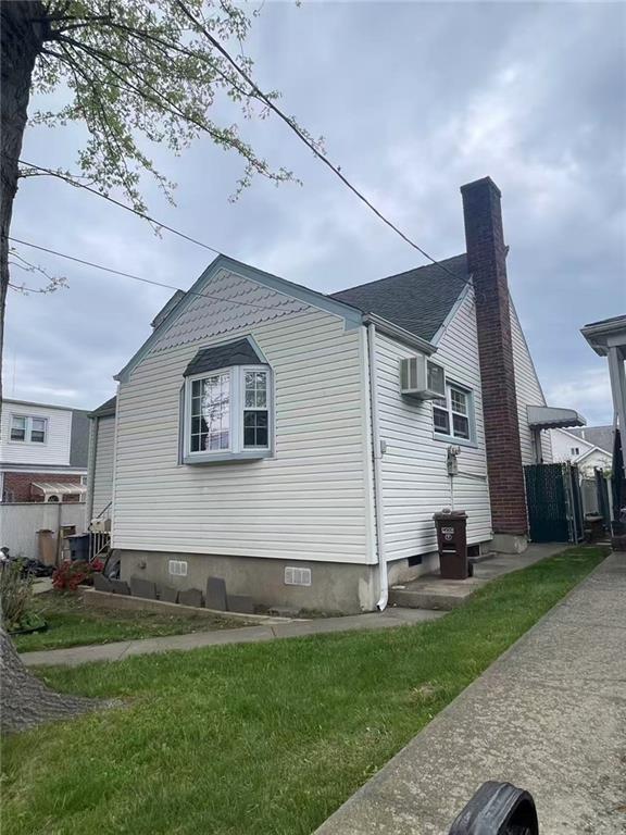 523 Woolley Ave, Staten Island, NY 10314 - view of side of property with crawl space and a chimney