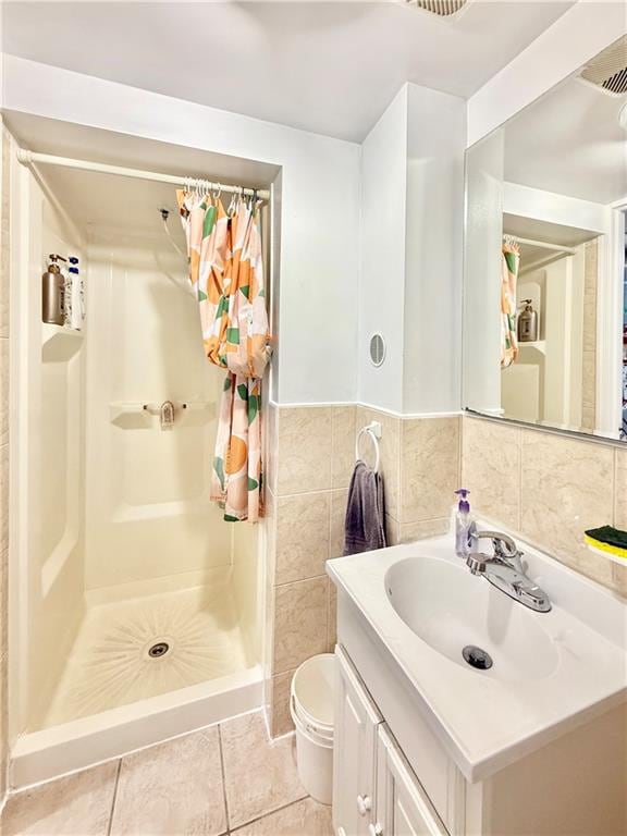1871 W 8th St, Brooklyn, NY 11223 - full bathroom featuring a stall shower, vanity, toilet, tile patterned flooring, and tile walls