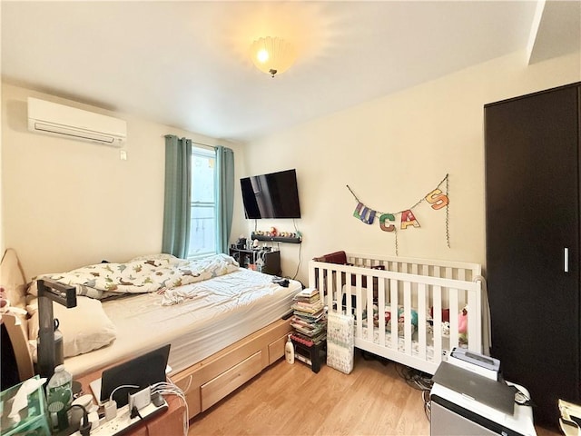 1871 W 8th St, Brooklyn, NY 11223 - bedroom with a wall unit AC and light wood-type flooring