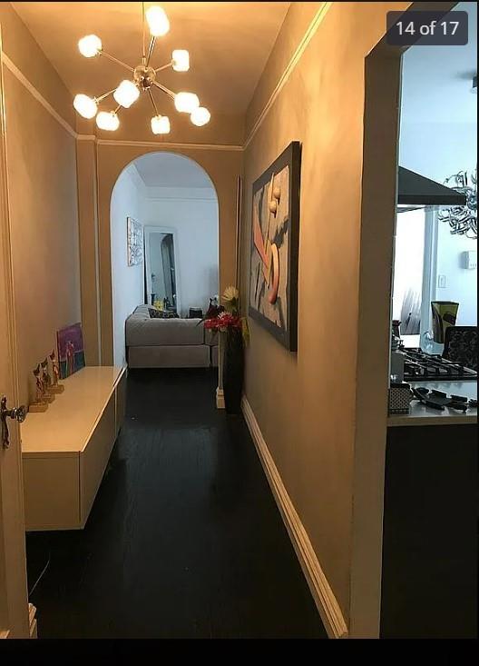 1440 Midland Ave Unit 1D, Bronxville, NY 10108 - hallway with arched walkways, a chandelier, and baseboards