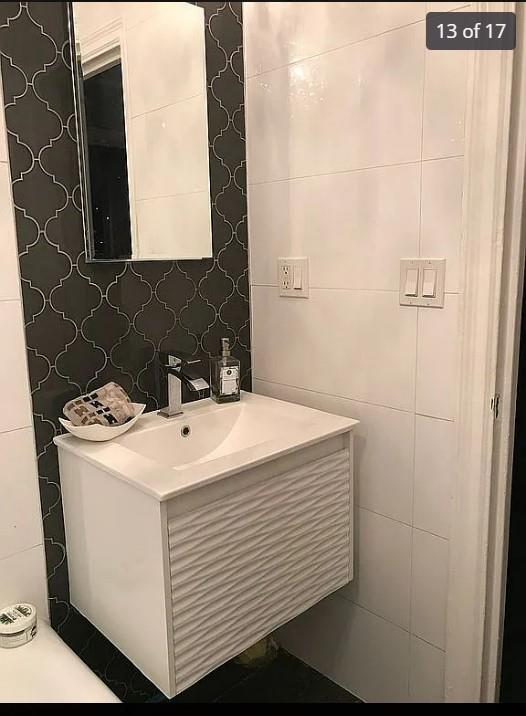 1440 Midland Ave Unit 1D, Bronxville, NY 10108 - half bath featuring vanity and tile walls