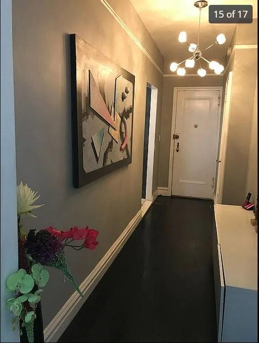 1440 Midland Ave Unit 1D, Bronxville, NY 10108 - hall with a chandelier, baseboards, and wood finished floors