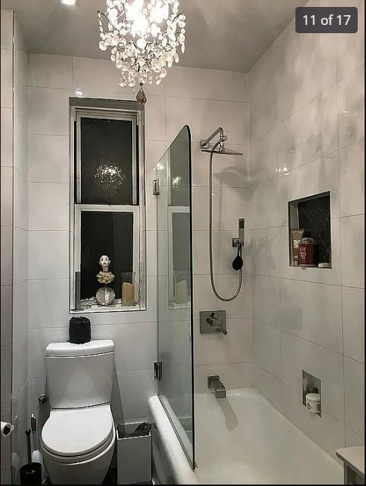 1440 Midland Ave Unit 1D, Bronxville, NY 10108 - full bathroom with shower / bathtub combination, toilet, and a chandelier