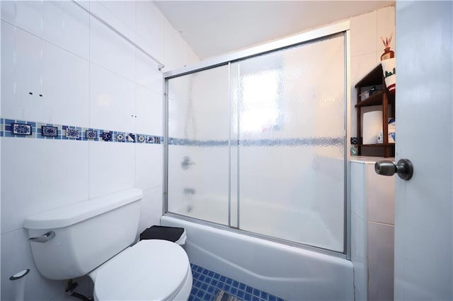 2543 W 16th St Unit C2, Brooklyn, NY 11214 - bathroom featuring toilet, tile walls, and bath / shower combo with glass door