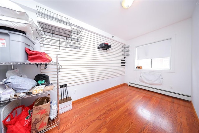 2543 W 16th St Unit C2, Brooklyn, NY 11214 - empty room featuring a baseboard heating unit, wood finished floors, and baseboards