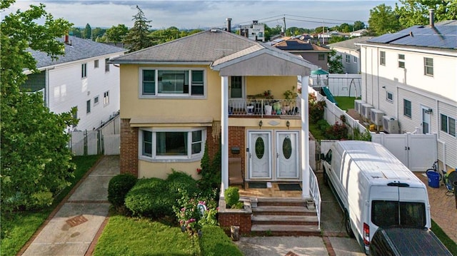 27 Bascom Pl, Staten Island, NY 10314 - multi unit property with a balcony, stucco siding, brick siding, a fenced backyard, and a residential view