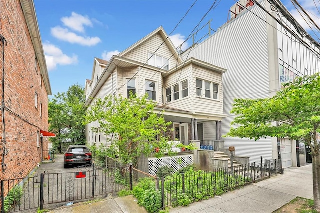 1816 Voorhies Ave, Brooklyn, NY 11235 - view of front facade featuring a porch, a fenced front yard, and a gate