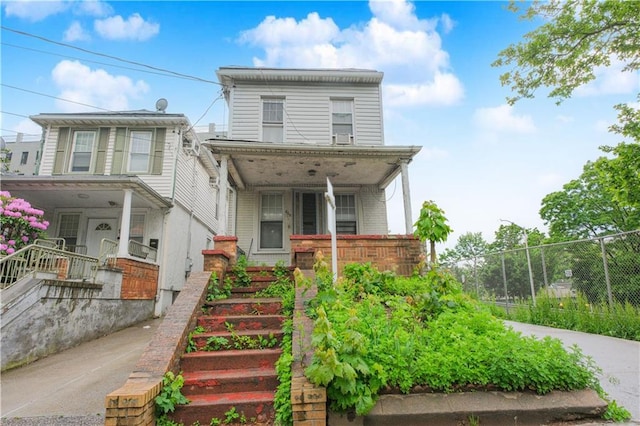 660 85th St, Brooklyn, NY 11228 - view of front facade featuring covered porch, stairway, and brick siding