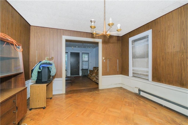 660 85th St, Brooklyn, NY 11228 - dining space featuring a baseboard heating unit, a chandelier, and wooden walls