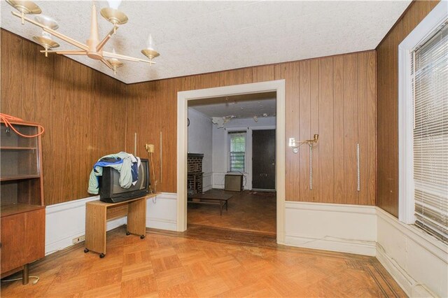 660 85th St, Brooklyn, NY 11228 - spare room with a chandelier and wood walls