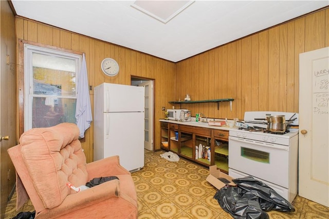 660 85th St, Brooklyn, NY 11228 - kitchen with white appliances, wooden walls, brown cabinetry, and light floors