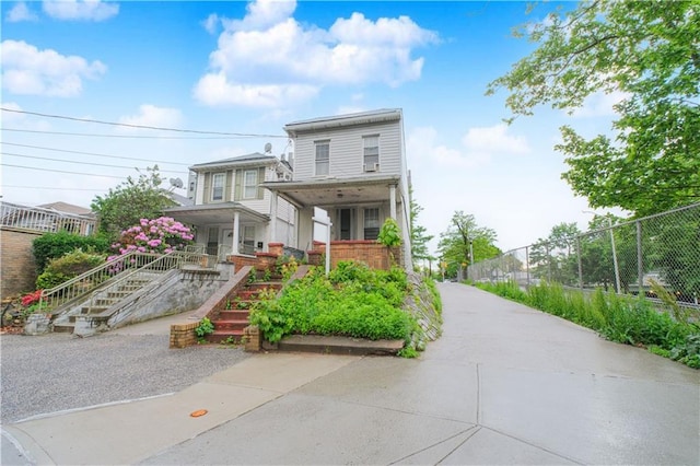 660 85th St, Brooklyn, NY 11228 - view of front facade featuring a porch, brick siding, and stairway