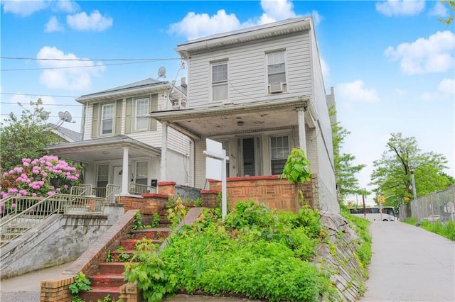 660 85th St, Brooklyn, NY 11228 - view of front of home featuring a porch, stairway, brick siding, and cooling unit