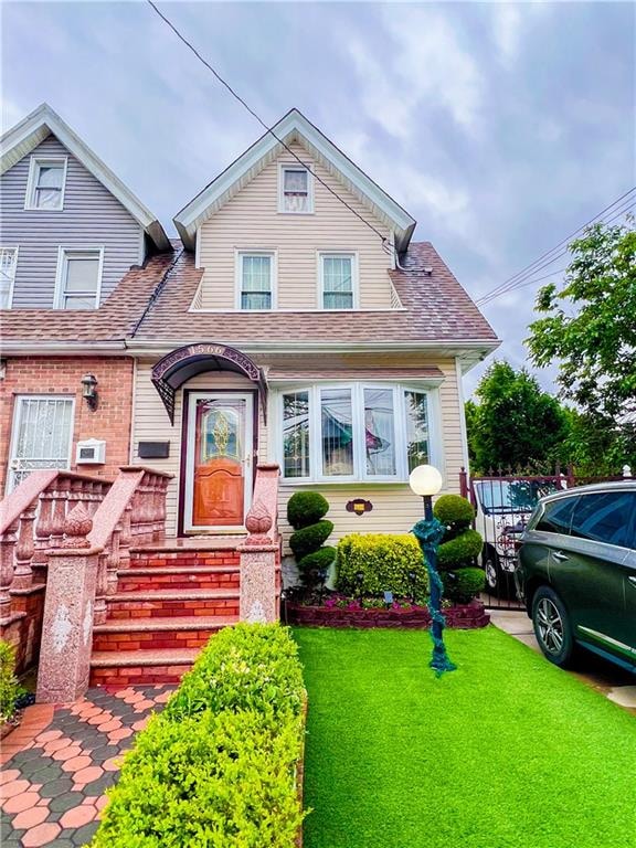 1566 E 46th St, Brooklyn, NY 11234 - view of front of home featuring a front yard and roof with shingles