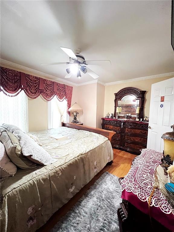 1566 E 46th St, Brooklyn, NY 11234 - bedroom featuring ornamental molding, light wood-style flooring, and ceiling fan