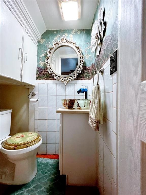 1566 E 46th St, Brooklyn, NY 11234 - bathroom with tile walls, toilet, vanity, and tile patterned flooring