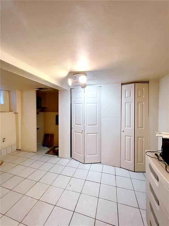 1566 E 46th St, Brooklyn, NY 11234 - finished basement featuring light tile patterned floors