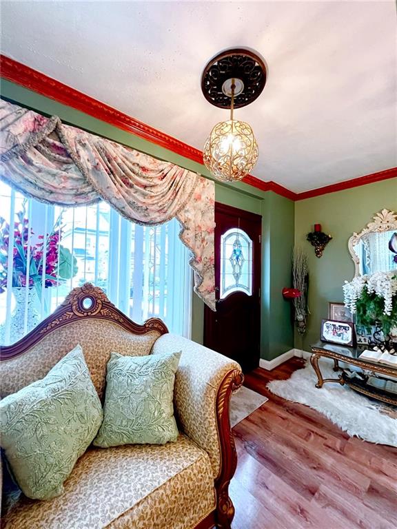 1566 E 46th St, Brooklyn, NY 11234 - living area featuring baseboards, wood finished floors, and crown molding