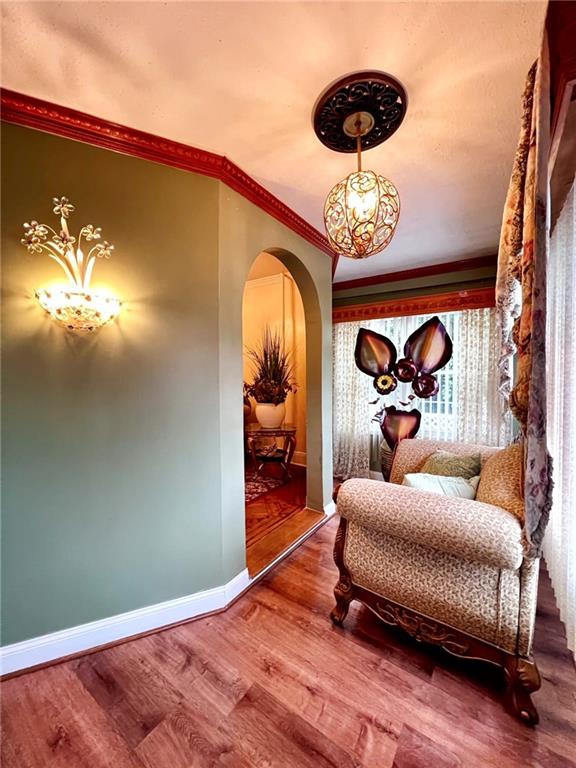 1566 E 46th St, Brooklyn, NY 11234 - sitting room with arched walkways, wood finished floors, baseboards, crown molding, and healthy amount of natural light