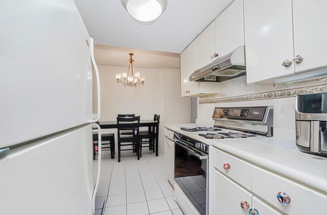 755 Narrows Rd N Unit 602, Staten Island, NY 10304 - kitchen with white appliances, under cabinet range hood, a chandelier, light tile patterned flooring, and white cabinets