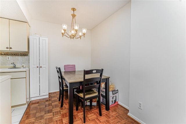 755 Narrows Rd N Unit 602, Staten Island, NY 10304 - dining area featuring a chandelier, baseboards, and washer / dryer
