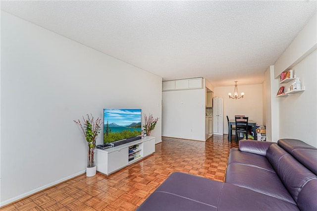 755 Narrows Rd N Unit 602, Staten Island, NY 10304 - living area featuring a chandelier, a textured ceiling, and baseboards