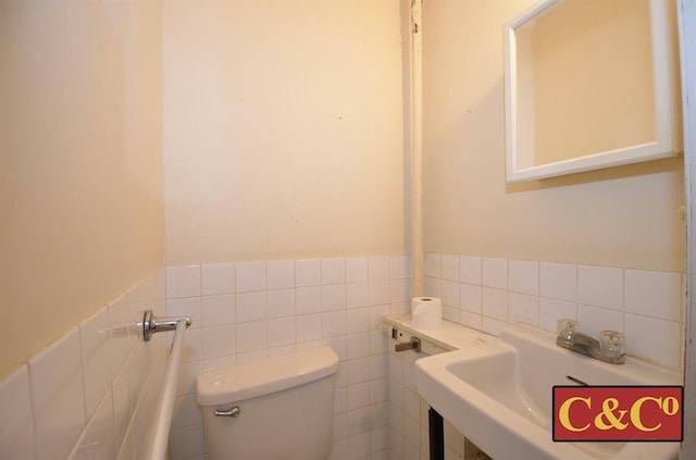 1927 E 34th St, Brooklyn, NY 11234 - half bathroom with toilet, tile walls, a wainscoted wall, and a sink