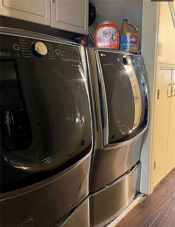 2054 Richomond Ave, New Springville, NY 10314 - laundry area featuring separate washer and dryer, cabinet space, and wood finished floors