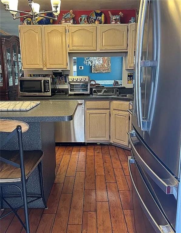 2054 Richomond Ave, New Springville, NY 10314 - kitchen featuring stainless steel appliances, dark countertops, dark wood-style flooring, and light brown cabinets
