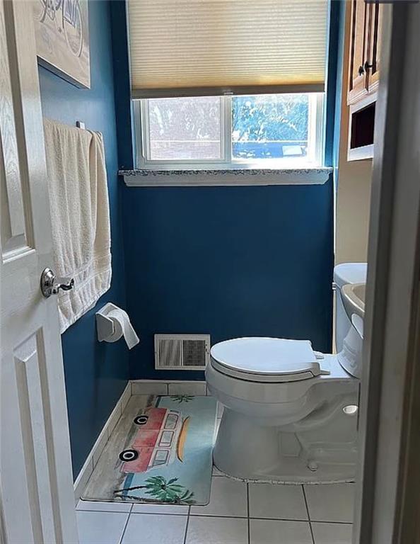 2054 Richomond Ave, New Springville, NY 10314 - bathroom featuring tile patterned flooring, toilet, and healthy amount of natural light
