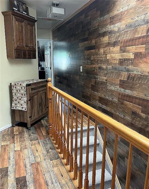 2054 Richomond Ave, New Springville, NY 10314 - hallway with dark wood-style floors, an upstairs landing, and baseboards