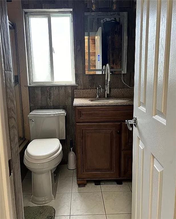 2054 Richomond Ave, New Springville, NY 10314 - bathroom with vanity, tile patterned flooring, toilet, and a stall shower