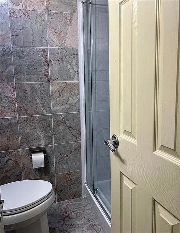 2054 Richomond Ave, New Springville, NY 10314 - bathroom featuring a shower stall, marble finish flooring, and toilet
